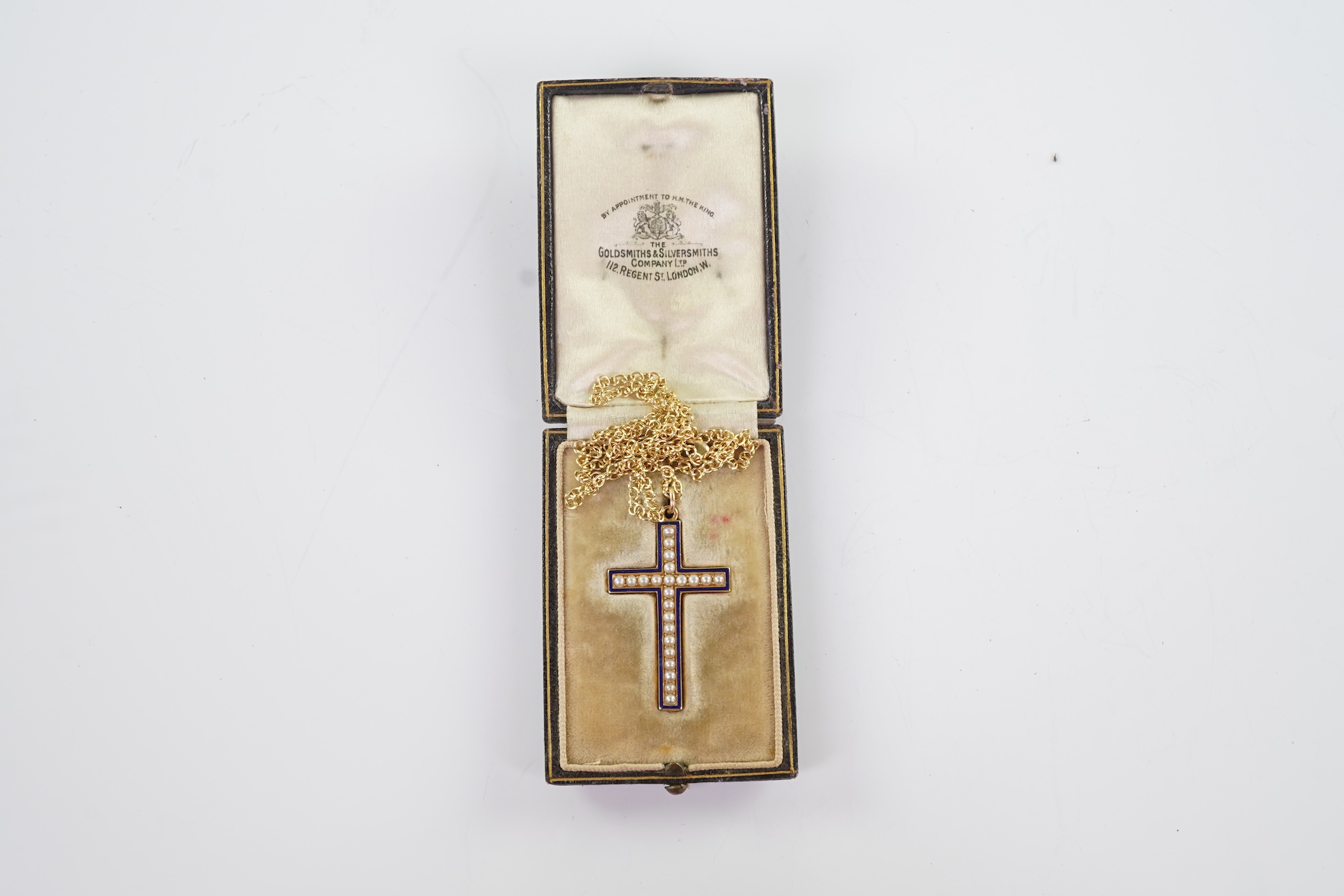 An Edwardian pearl and enamel cross and chain, early 20th century